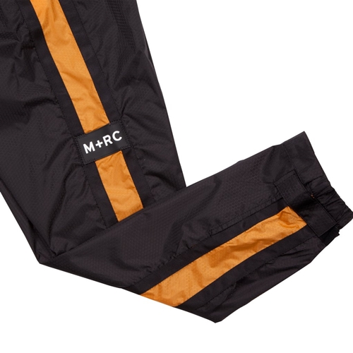 M+RC NOIR PLUG BLACK&ORANGE Track Pants | KingStar